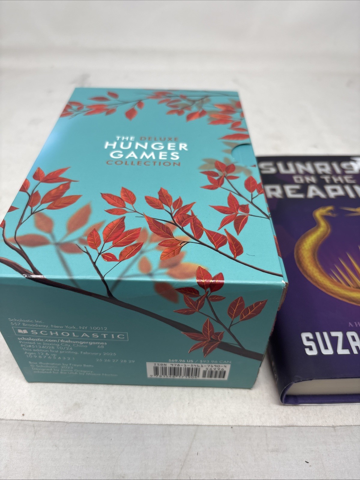 The Deluxe Hunger Games collection paperback + hard cover sunrise on the reaping